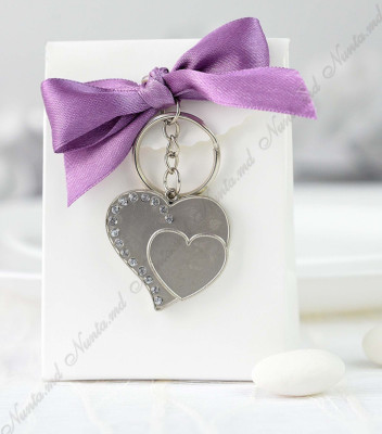 <p>Набор для бонбоньерок из белого картона украшенная фиолетовым бантиком и металлическими аксессуарами в форме сердца.</p>
